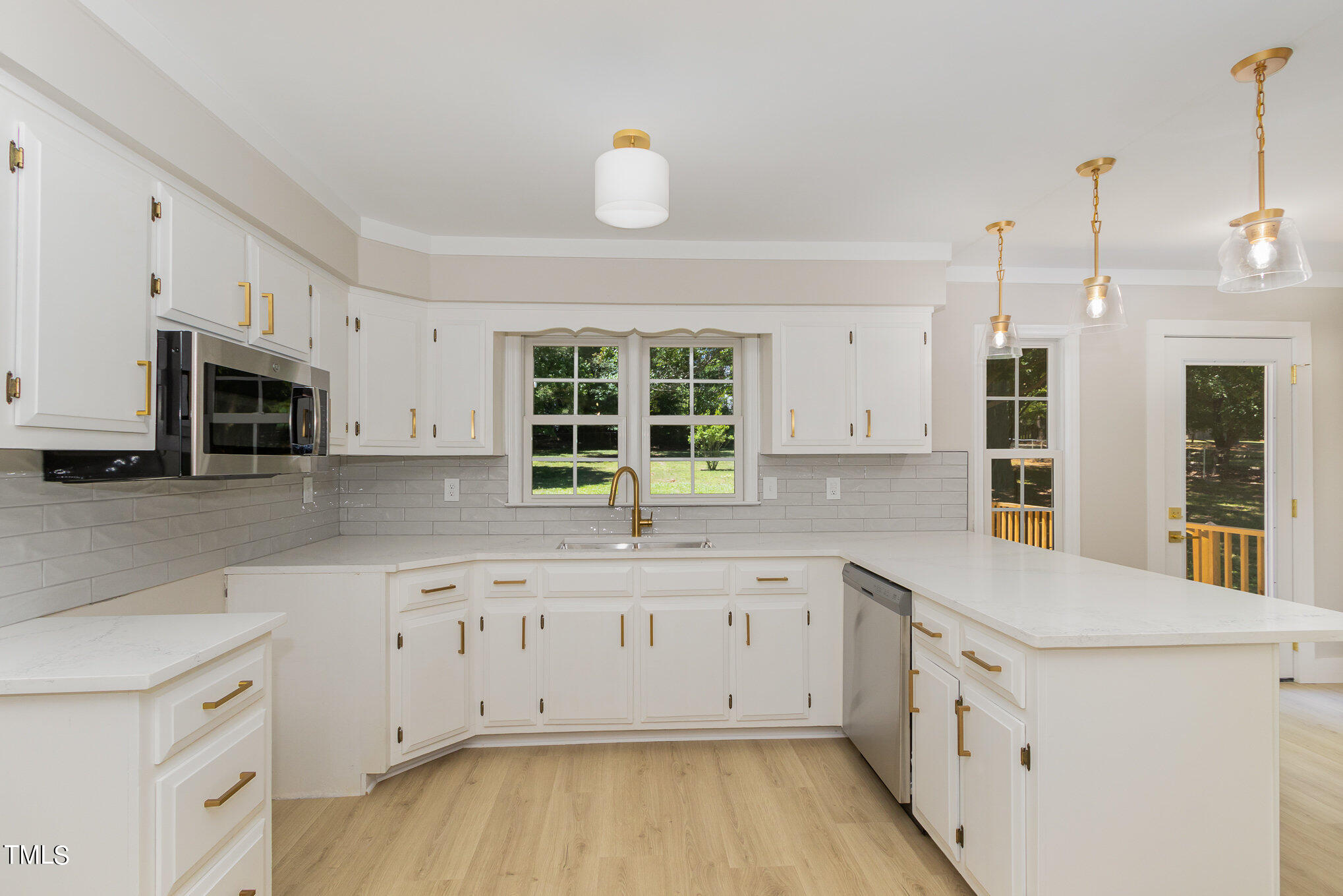 2008 Umstead Road Durham, NC 27712 - Photo 2 of 34 a kitchen with granite countertop white cabinets and window