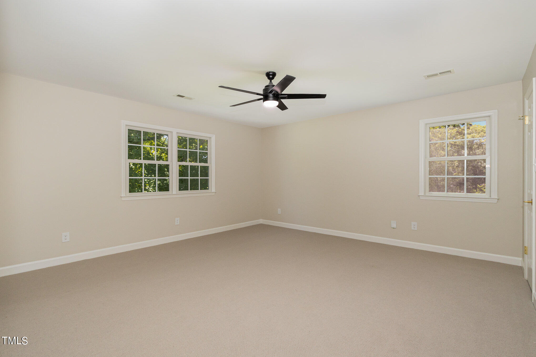 2008 Umstead Road Durham, NC 27712 - Photo 21 of 34 an empty room with windows and a ceiling fan