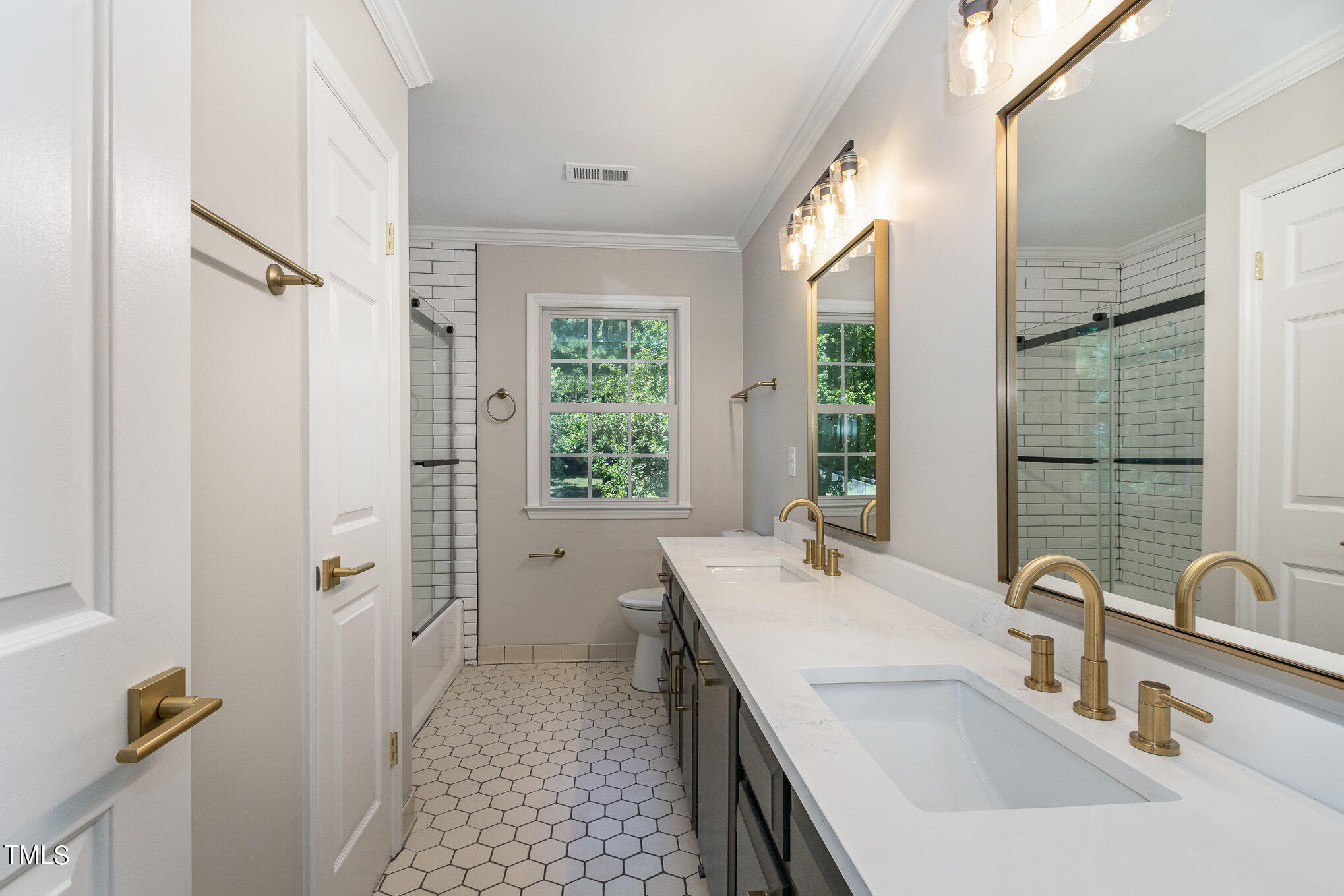 2008 Umstead Road Durham, NC 27712 - Photo 26 of 34 a bathroom with a double vanity sink a mirror and a shower