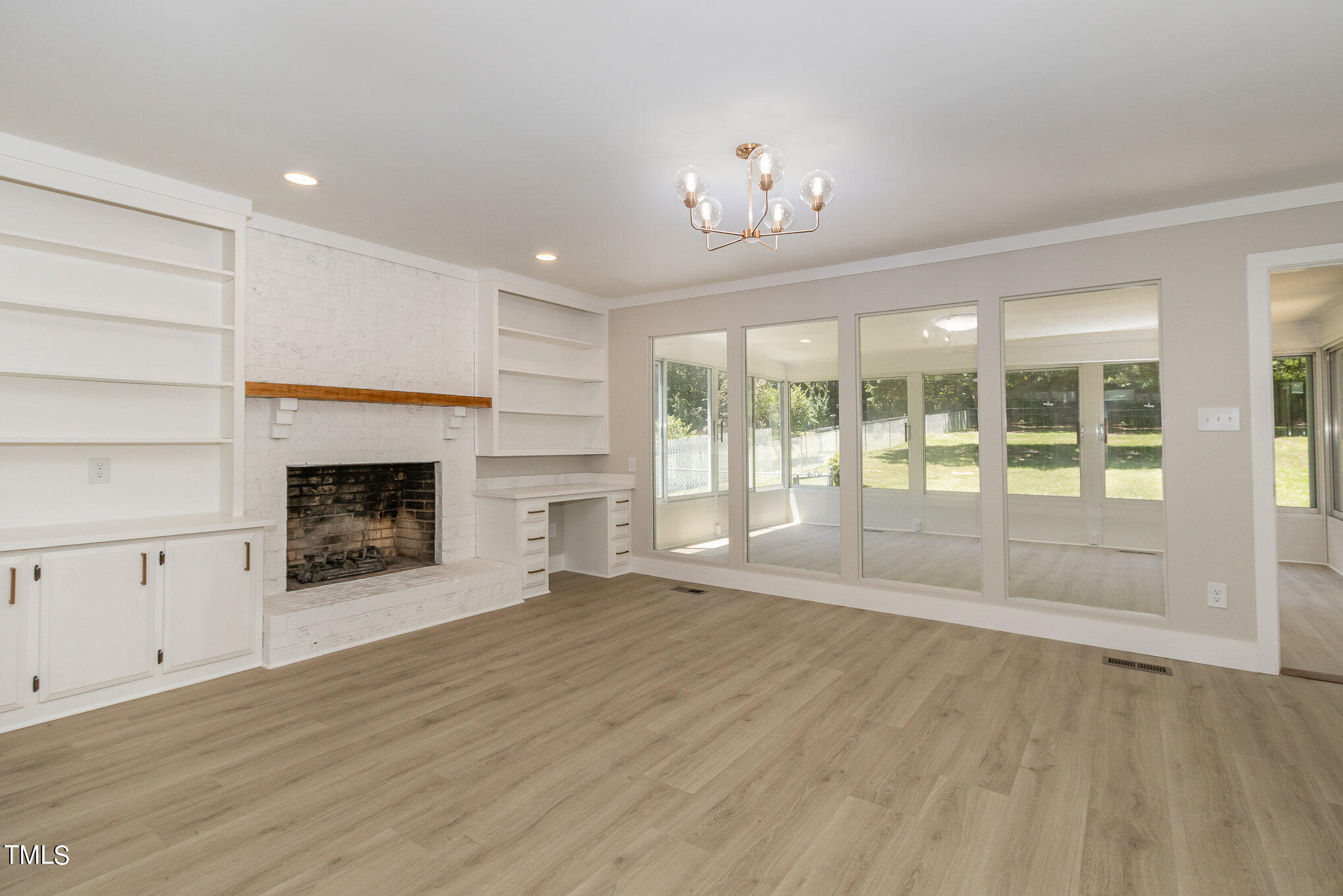 2008 Umstead Road Durham, NC 27712 - Photo 4 of 34 a view of an empty room with wooden floor fireplace and a window