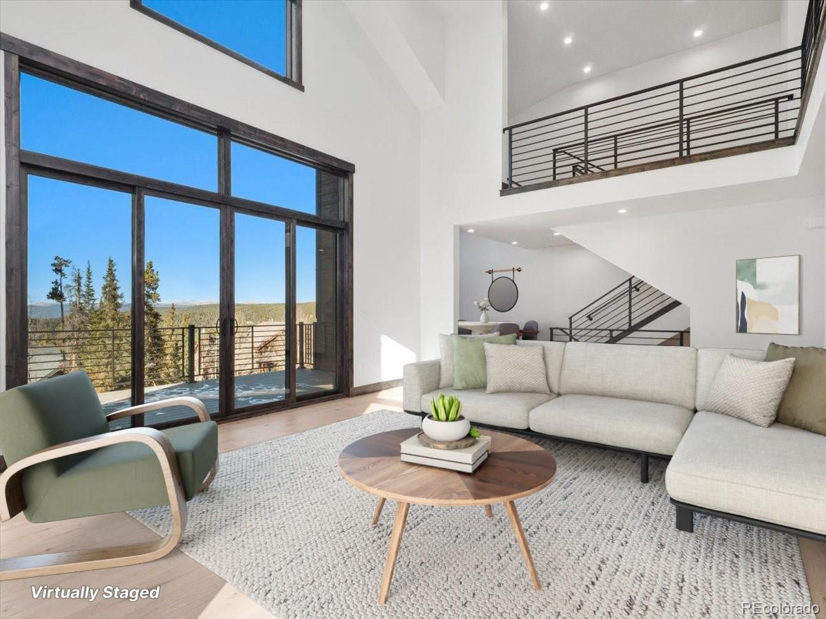 a living room with furniture and a floor to ceiling window