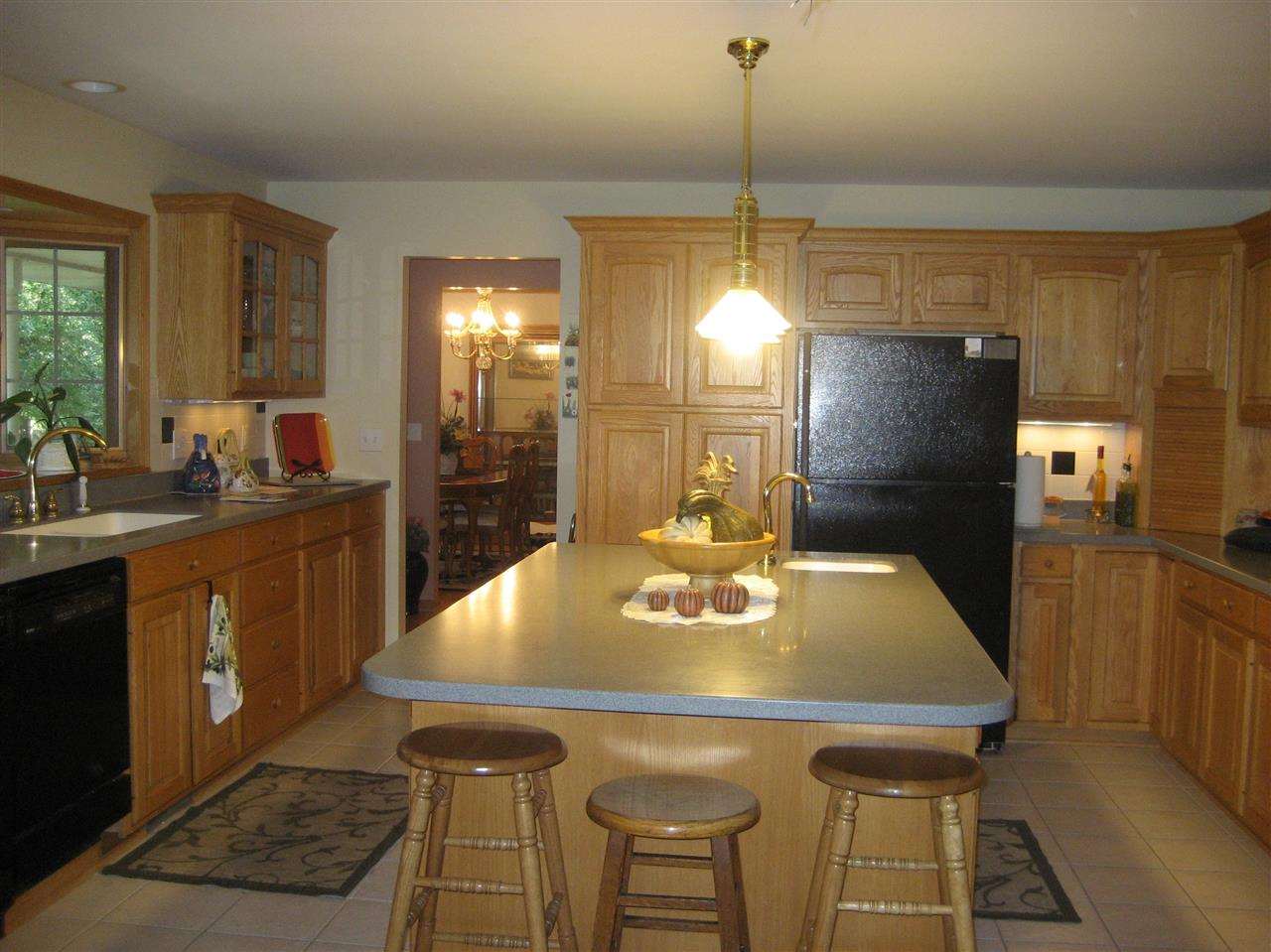 2401 South Watertown Road Oregon, IL 61061 - Photo 18 of 24 a kitchen with a sink a refrigerator and cabinets