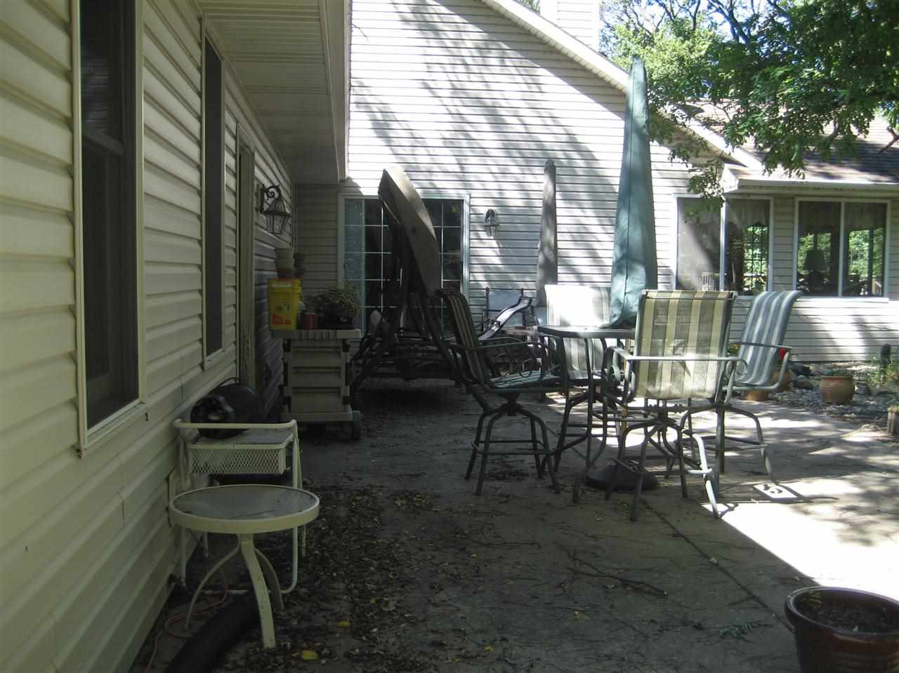 2401 South Watertown Road Oregon, IL 61061 - Photo 20 of 24 a view of a patio with table and chairs and floor to ceiling window