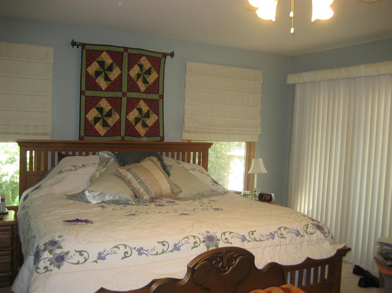 2401 South Watertown Road Oregon, IL 61061 - Photo 7 of 24 a bedroom with a bed and a window