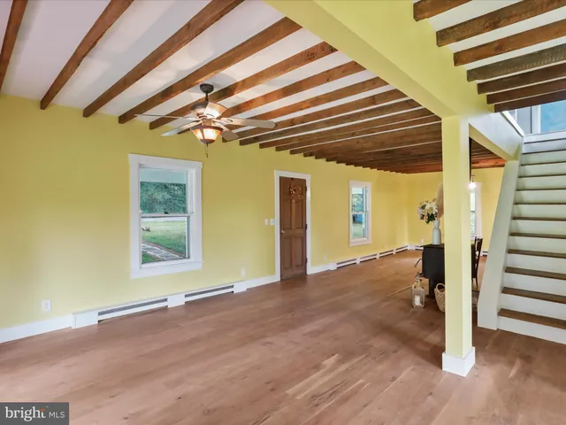 a view of a livingroom with furniture and garden view