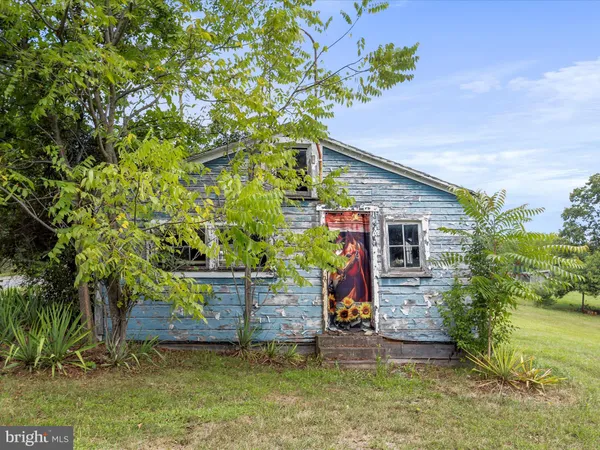 a front view of a house with a yard and a garden