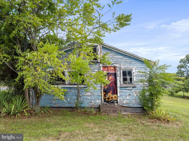 a front view of a house with a yard and a garden