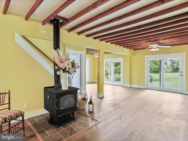 a kitchen with a table chairs microwave and cabinets