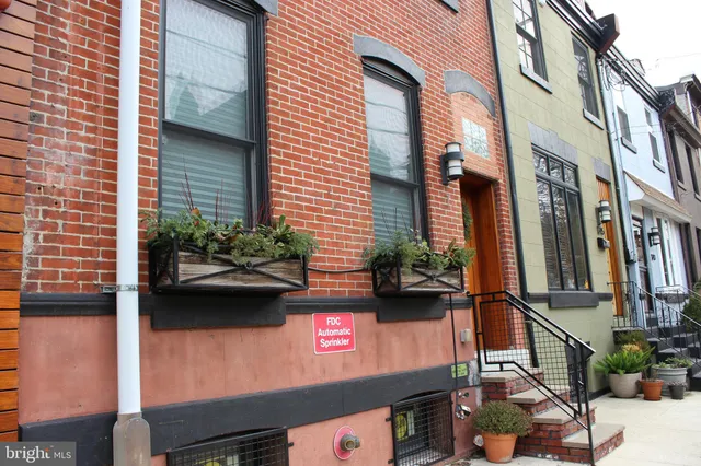 a view of a street with potted plants