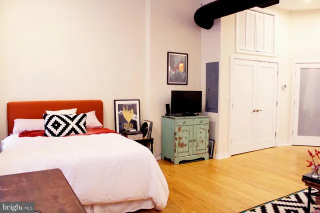 a bedroom with a bed and a flat screen tv