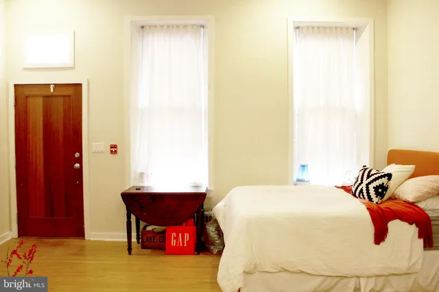 a bedroom with a bed and a mirror