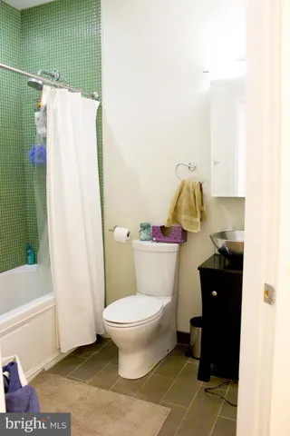 a bathroom with a toilet and a shower