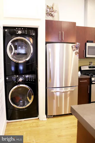 a kitchen with a refrigerator and washer