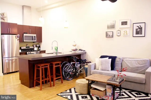 a kitchen with a sink cabinets and refrigerator