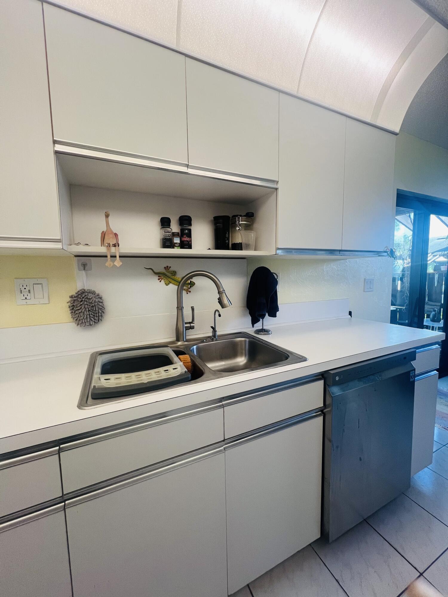 14109 Nesting Way Delray Beach, FL 33484 - Photo 12 of 12 a kitchen with a sink a stove and cabinets