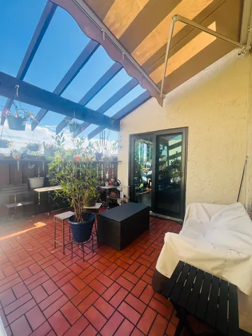 a balcony with furniture and a patio