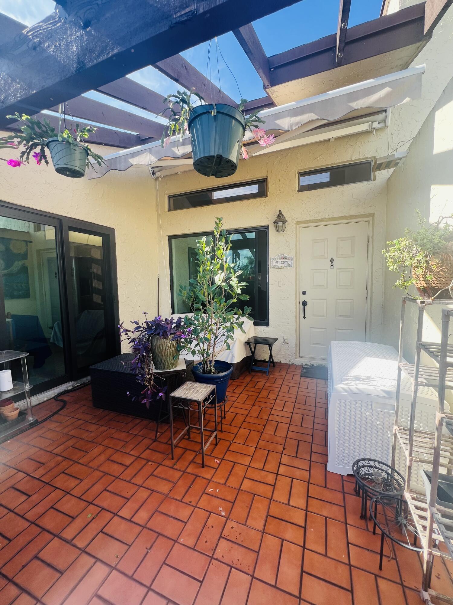 14109 Nesting Way Delray Beach, FL 33484 - Photo 4 of 12 a living room with patio furniture and a large window