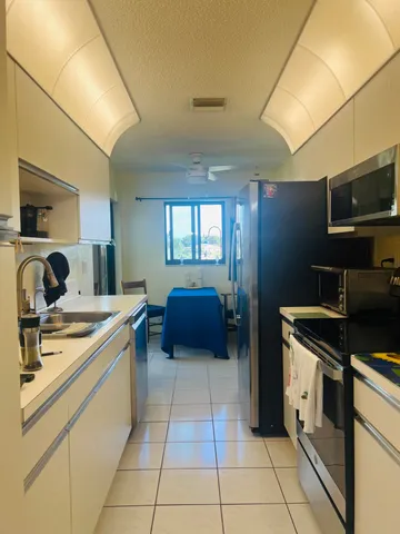 a kitchen with stainless steel appliances granite countertop a sink and cabinets