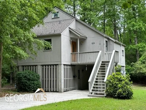 a view of a house with a yard and a garden