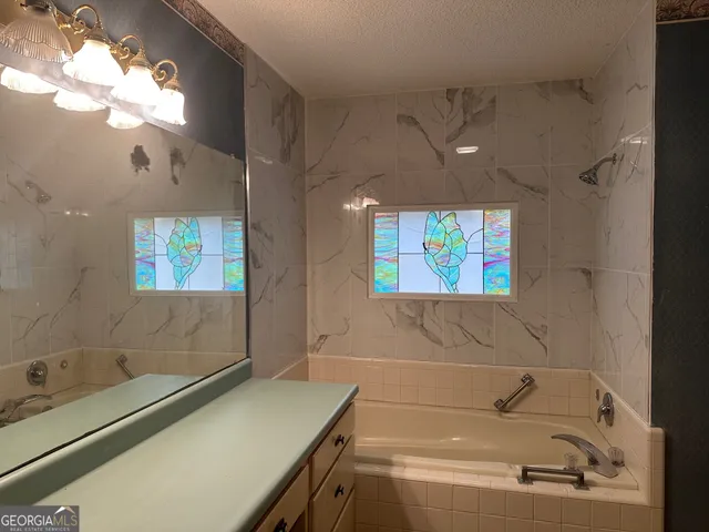 a bathroom with a sink a bathtub and a shower