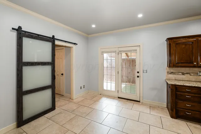 a view of a kitchen with an empty space and a window