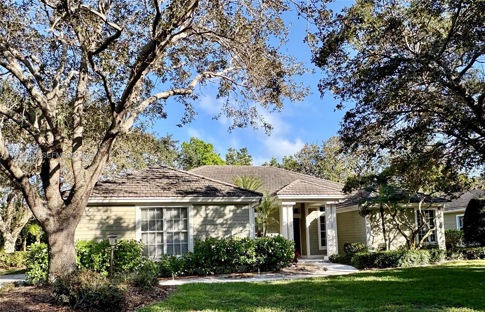 a front view of a house with a garden