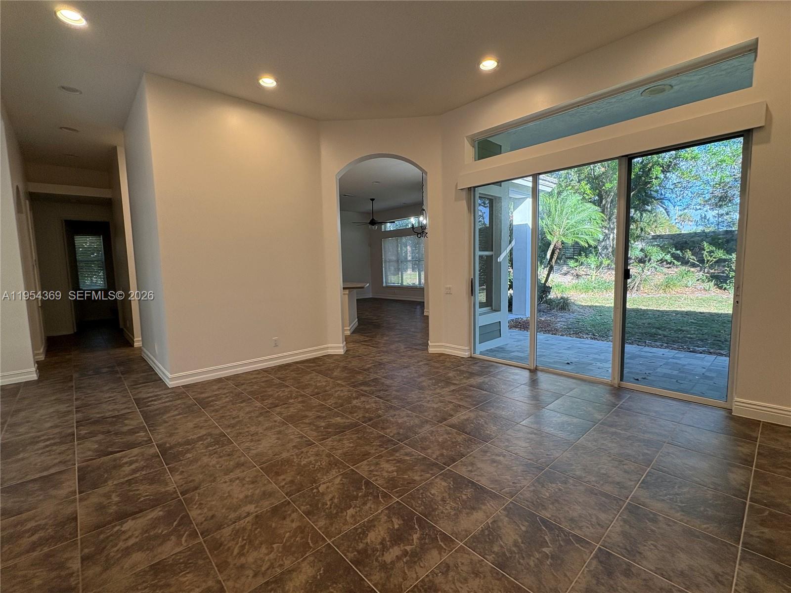 18265 Southeast Ridgeview Drive Tequesta, FL 33469 - Photo 2 of 12 a view of a big room with wooden floor and windows