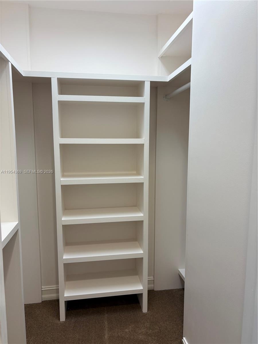 18265 Southeast Ridgeview Drive Tequesta, FL 33469 - Photo 9 of 12 a view of walk in closet with empty racks