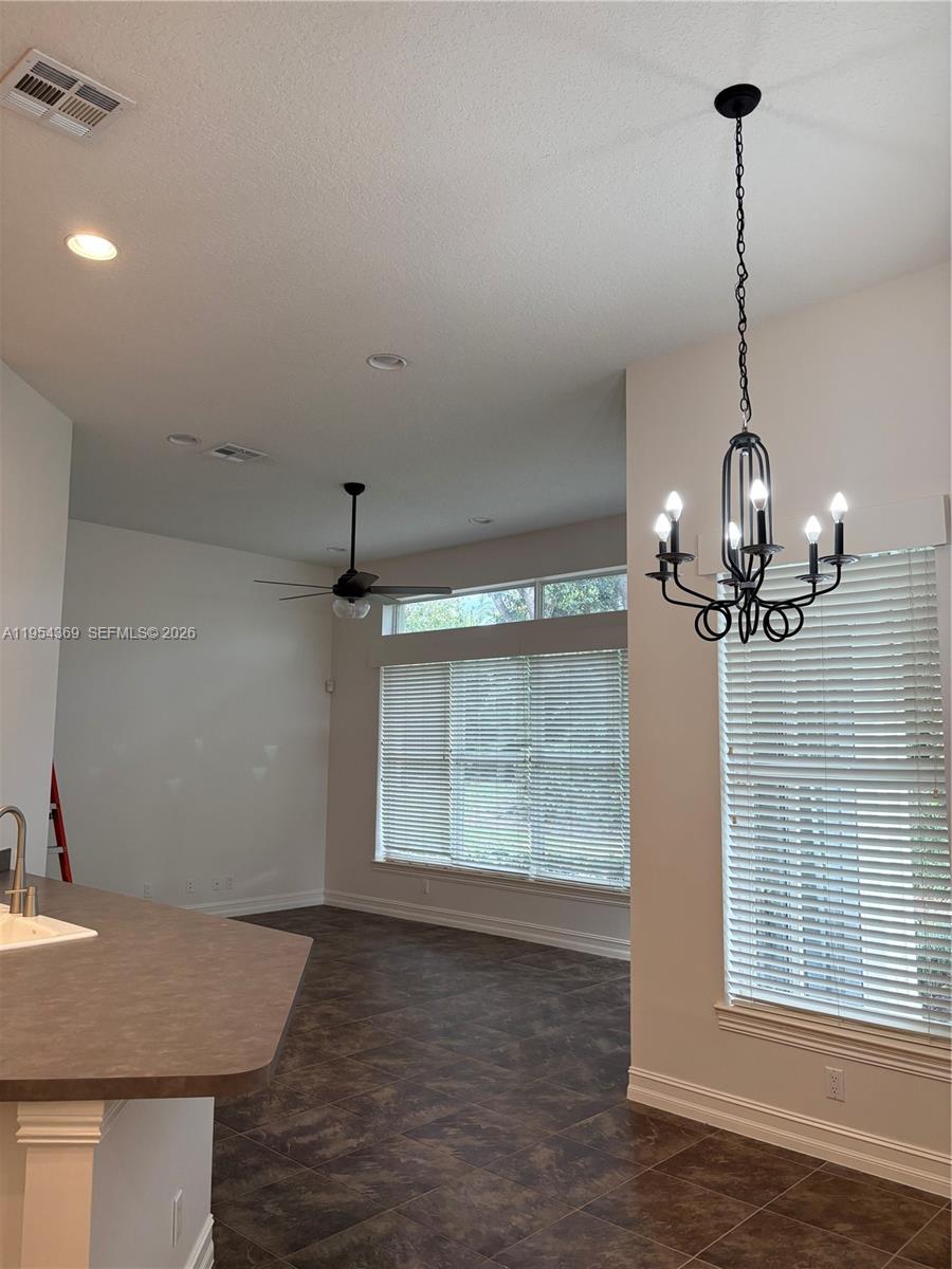 18265 Southeast Ridgeview Drive Tequesta, FL 33469 - Photo 10 of 12 a view of a room with wooden floor chandelier and entryway