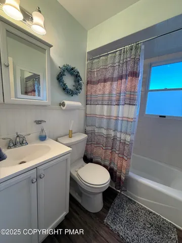 a bathroom with a toilet a sink and a shower