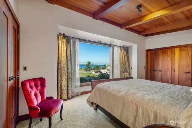 a bedroom with a bed chair and a window