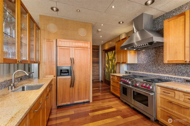 a kitchen with stainless steel appliances a sink stove and refrigerator