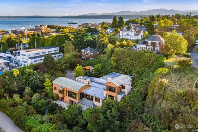 an aerial view of residential houses with outdoor space and swimming pool