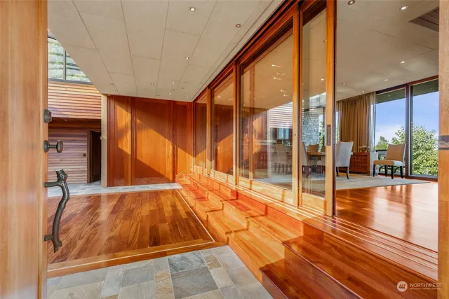 a room with wooden floor and windows