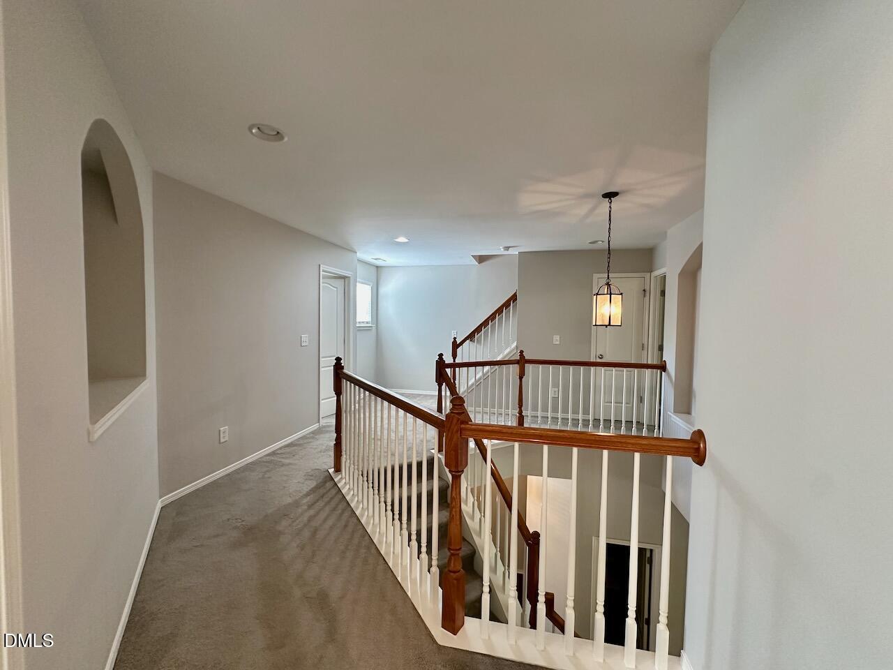 8208 Stone Cellar Drive Raleigh, NC 27613 - Photo 18 of 34 a view of staircase with railing and a chandelier