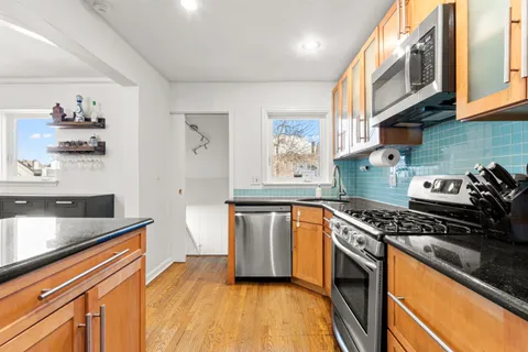 a kitchen with stainless steel appliances granite countertop a stove and a refrigerator