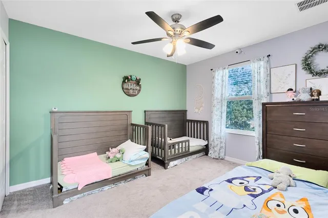 a bedroom with a bed and a chandelier