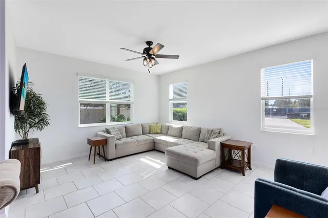a living room with furniture a clock and a chandelier