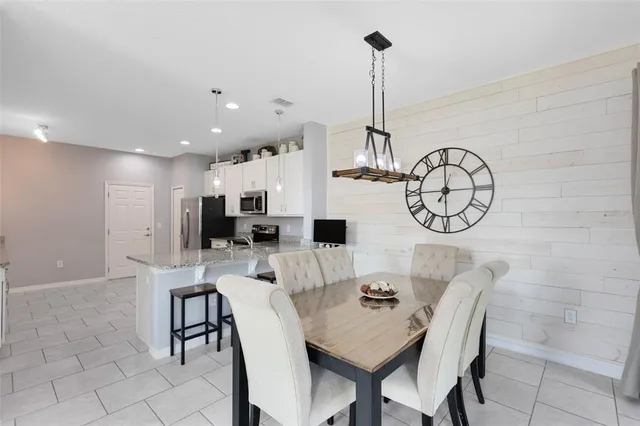 a view of a dining room with furniture and a chandelier