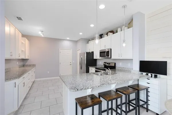 a kitchen with sink and cabinets