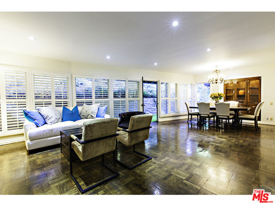a living room with furniture and floor to ceiling window