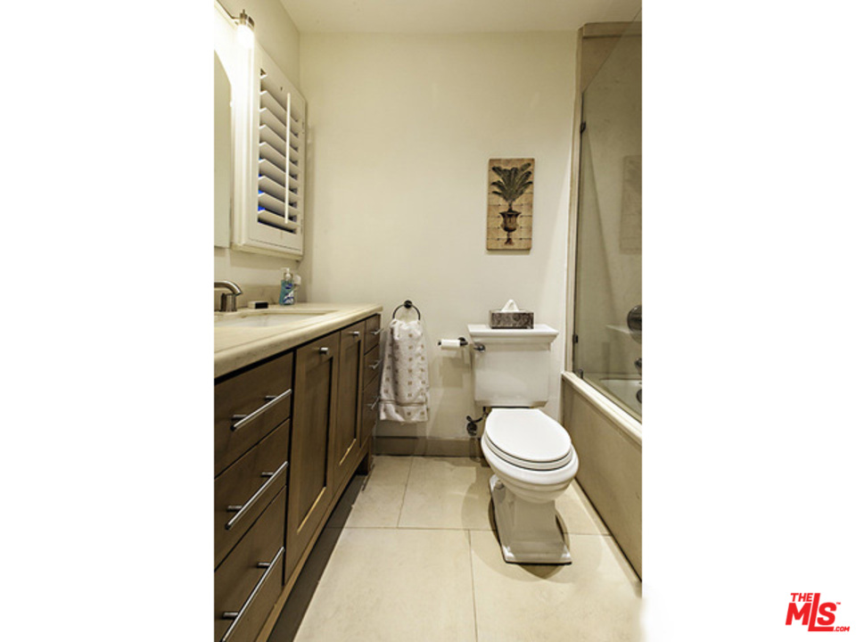 2559 Hutton Drive Beverly Hills, CA 90210 - Photo 6 of 13 a bathroom with a toilet a sink and a mirror