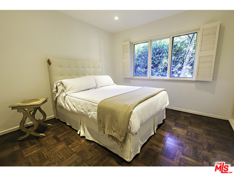 2559 Hutton Drive Beverly Hills, CA 90210 - Photo 7 of 13 a bed sitting in a bedroom next to a window