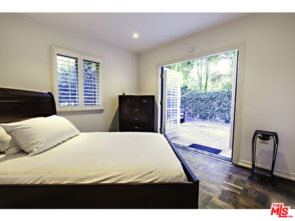 2559 Hutton Drive Beverly Hills, CA 90210 - Photo 8 of 13 a bedroom with a bed and wooden floor
