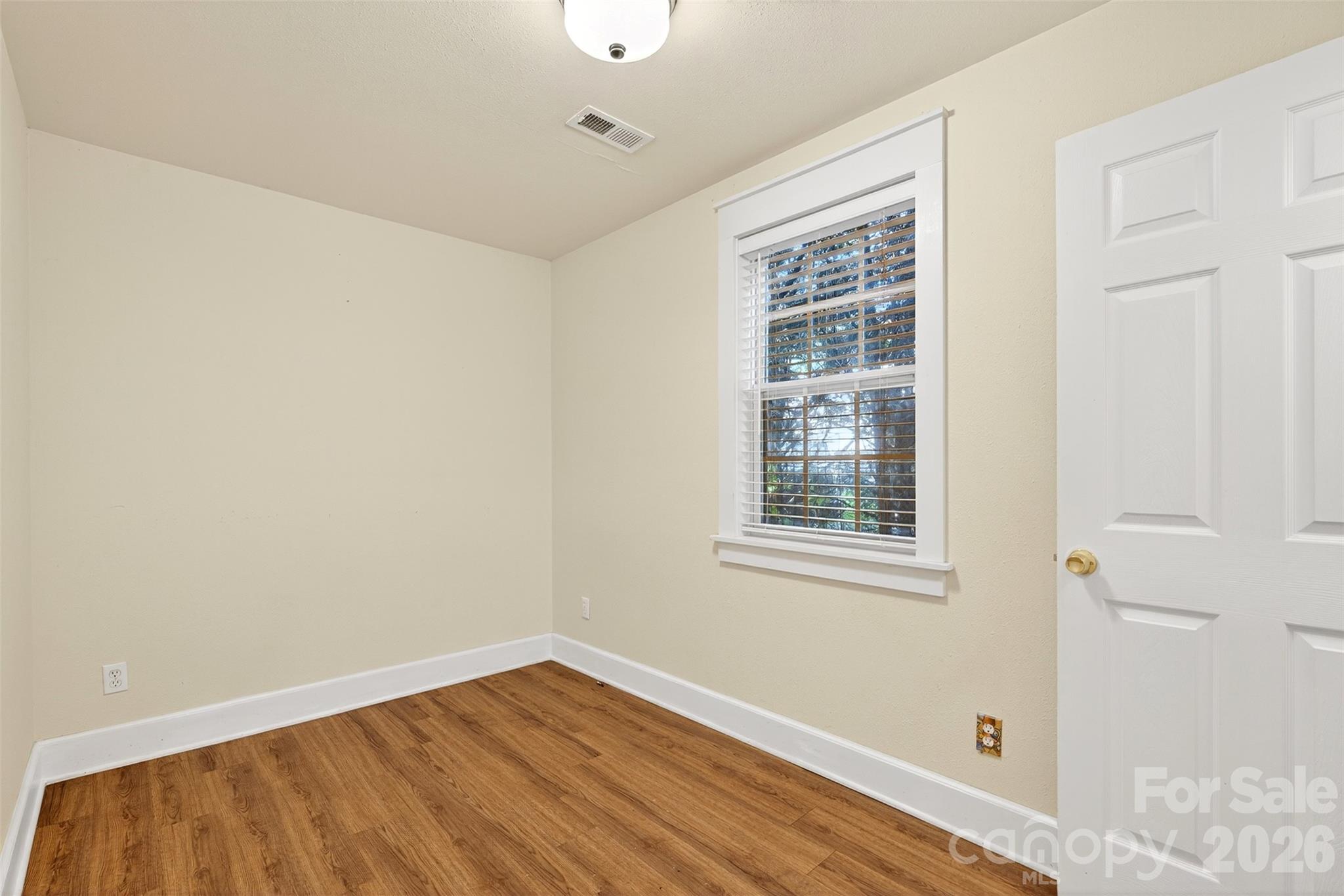 160 East Howard Street Tryon, NC 28782 - Photo 28 of 48 a view of an empty room with wooden floor and a window