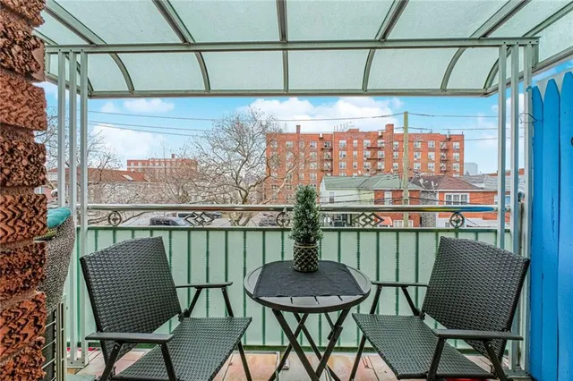 a view of a chairs and table in the balcony