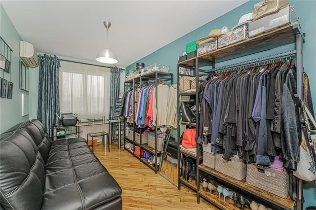 a view of walk in closet with clothes and shoes