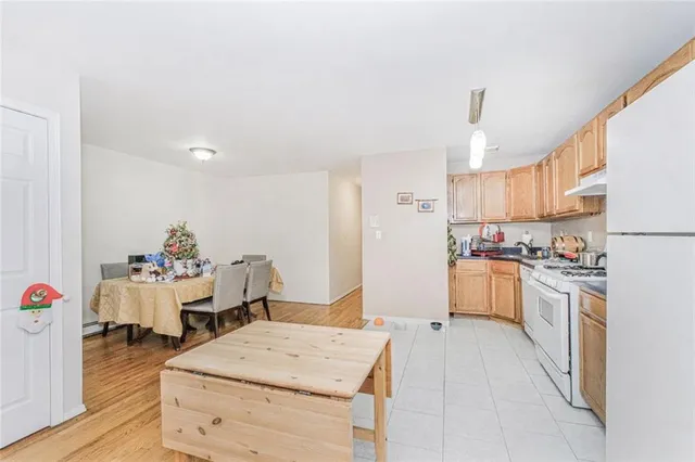 a kitchen with a refrigerator and white cabinets