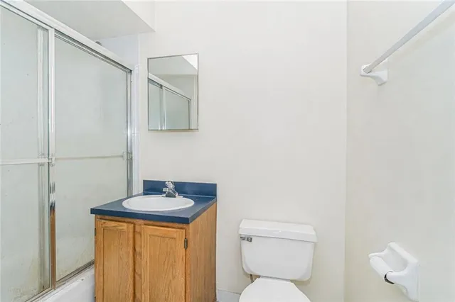 a bathroom with a sink a toilet and mirror