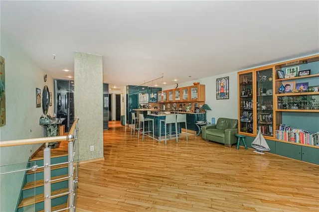 a living room with furniture and a book shelf